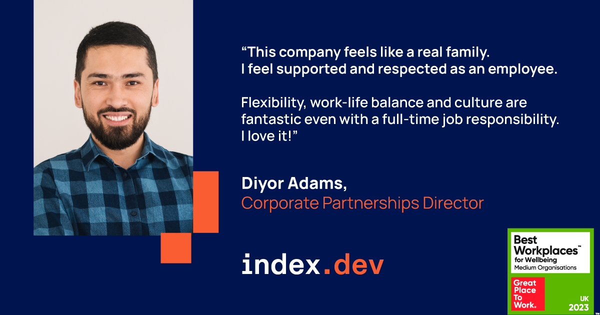 A smiling man with black hair on a light background