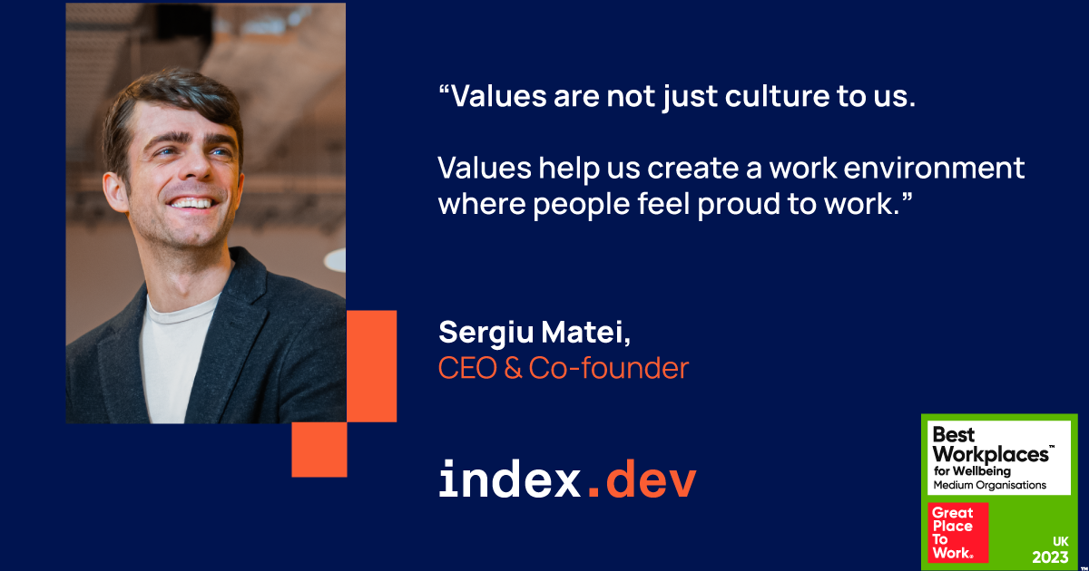 A headshot of a smiling man  with black hair