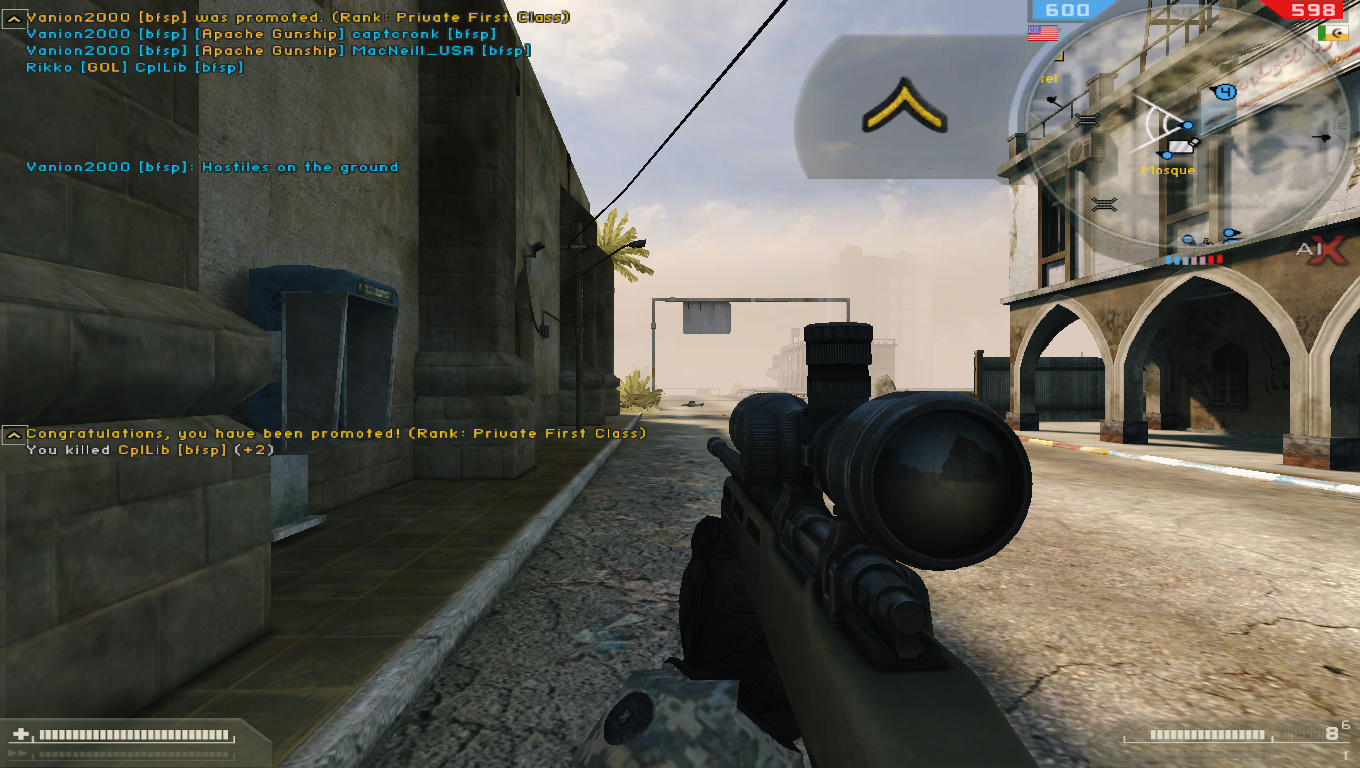 In-game screenshot of Battlefield 2 showing the player's sniper view in a multiplayer urban map.